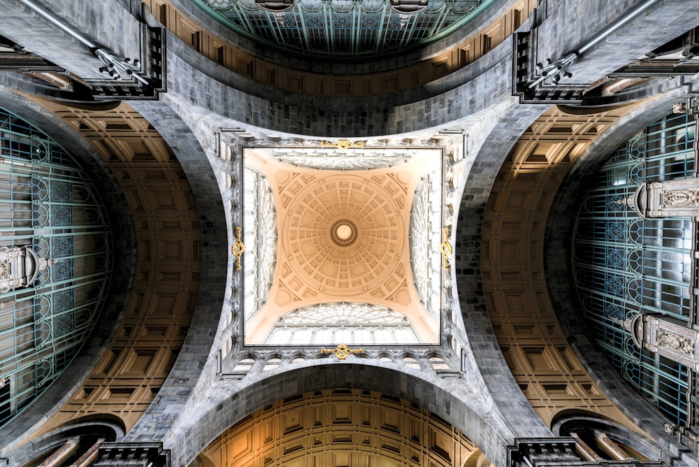 the ceiling of a building with a circular window