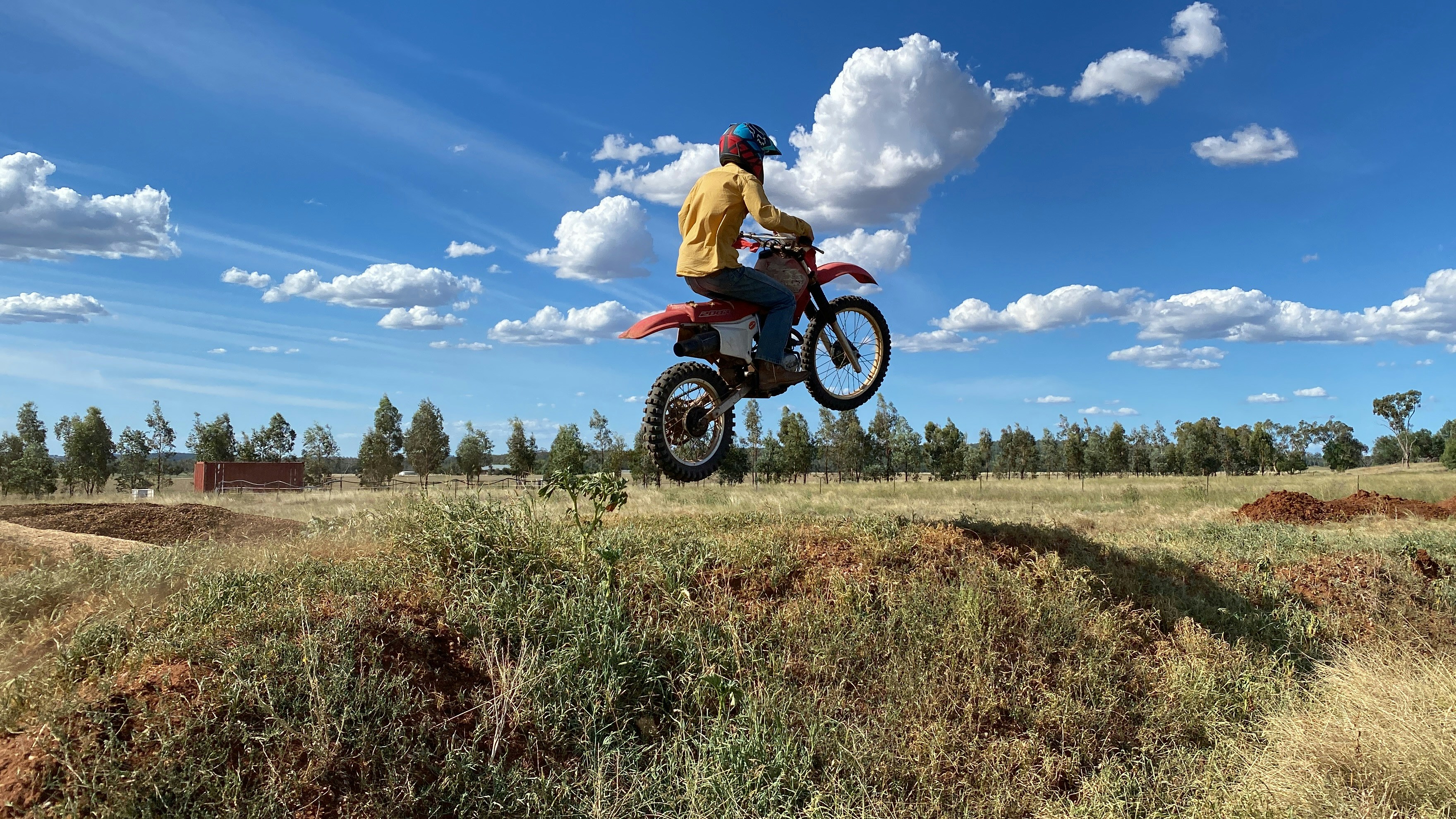 a person jumping a dirt bike in the air