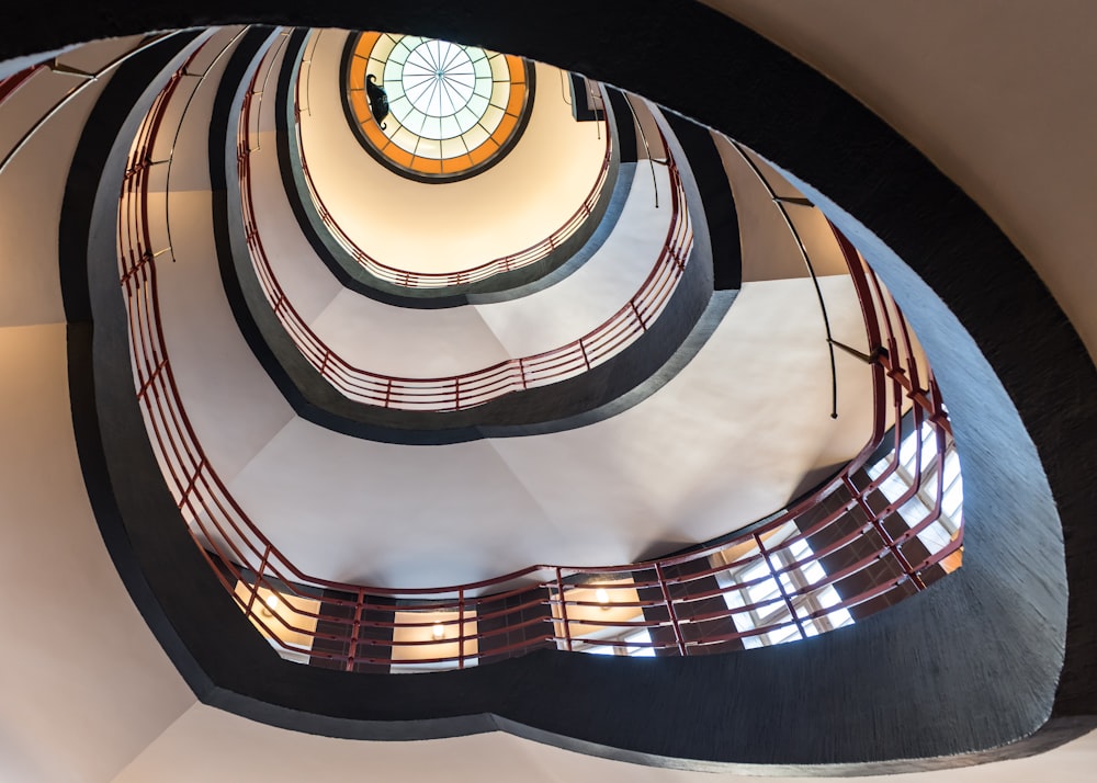 a spiral staircase in a building with a skylight