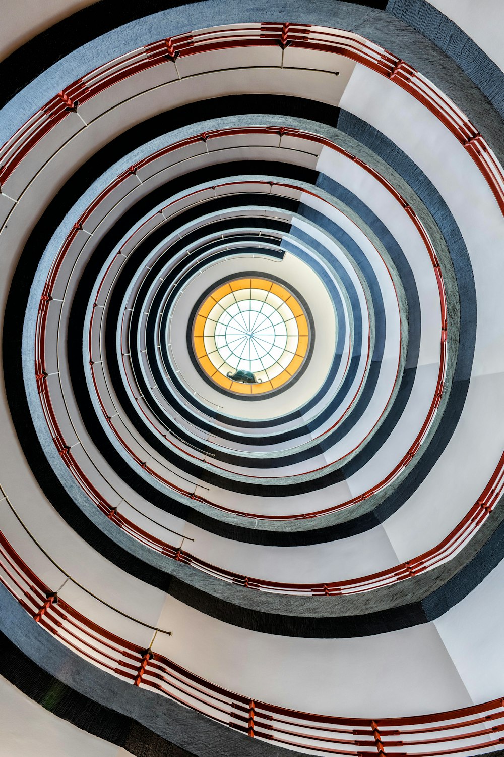 a spiral staircase with a circular window in the center