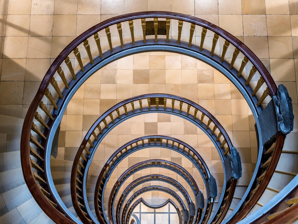 a spiral staircase in a building with tiled walls