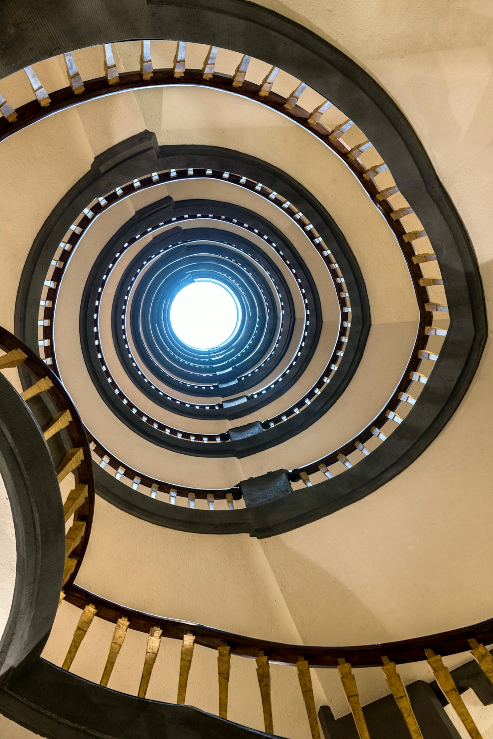 a spiral staircase with a light at the end