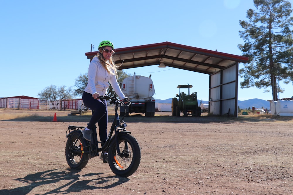 a woman riding a bike in front of a building