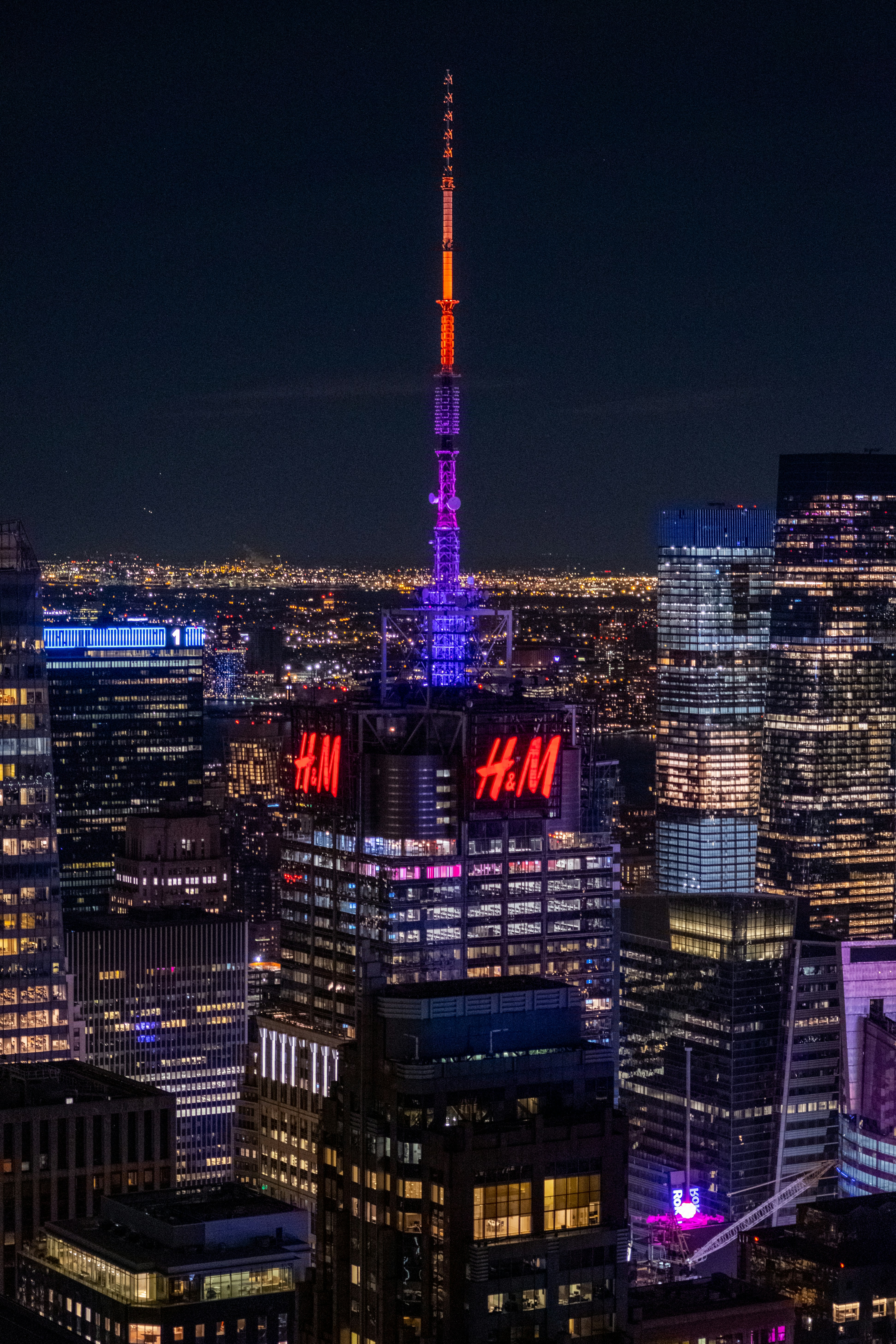 A view of a city at night from the top of a building photo – Free City ...