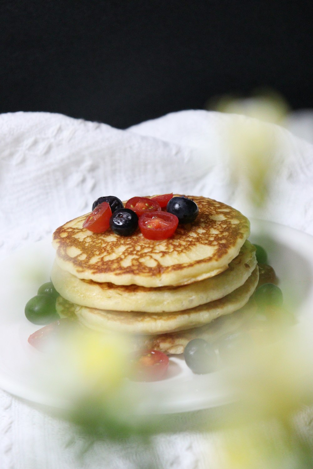 a stack of pancakes with berries on top