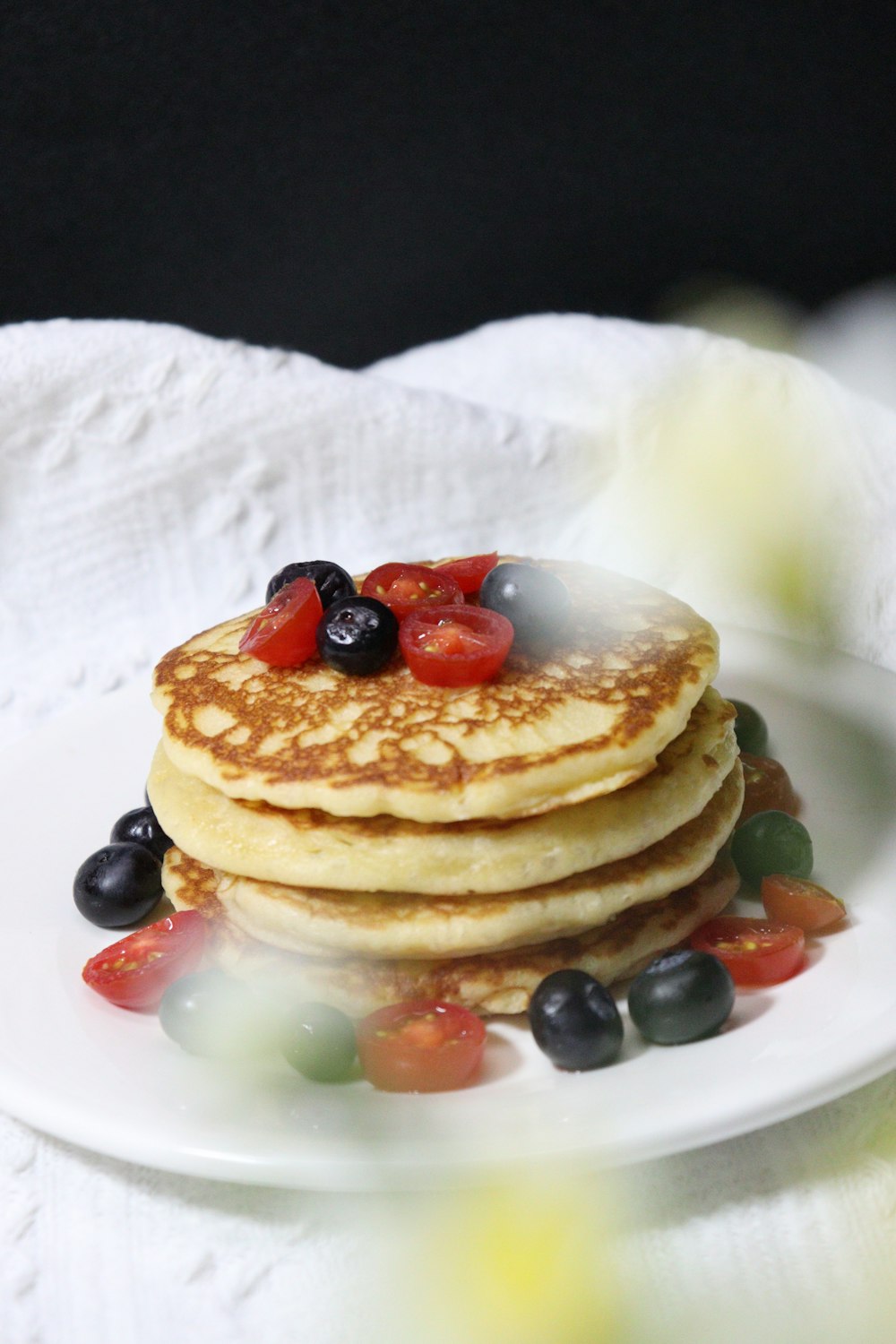 a stack of pancakes on a plate with jelly beans