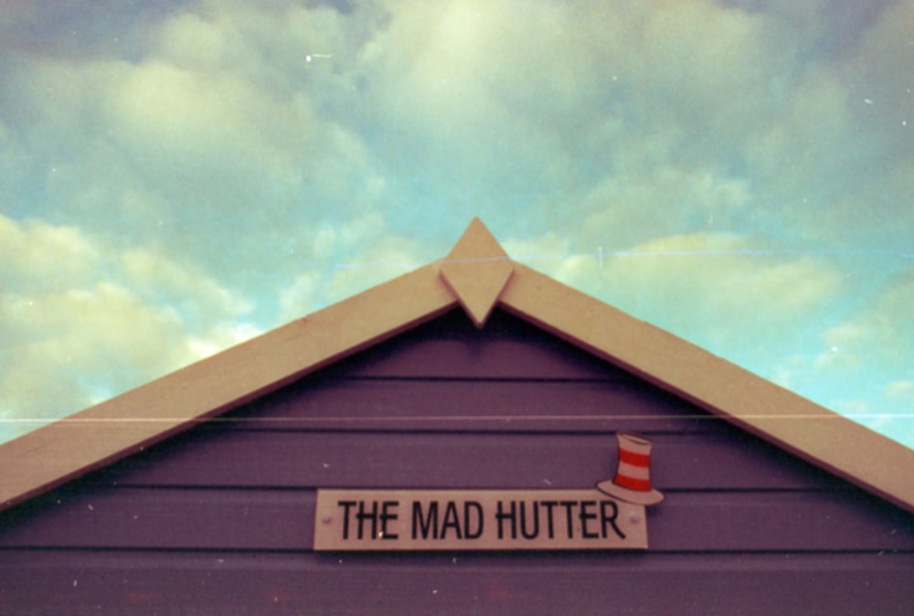 a sign on the side of a building that says the mad hutter