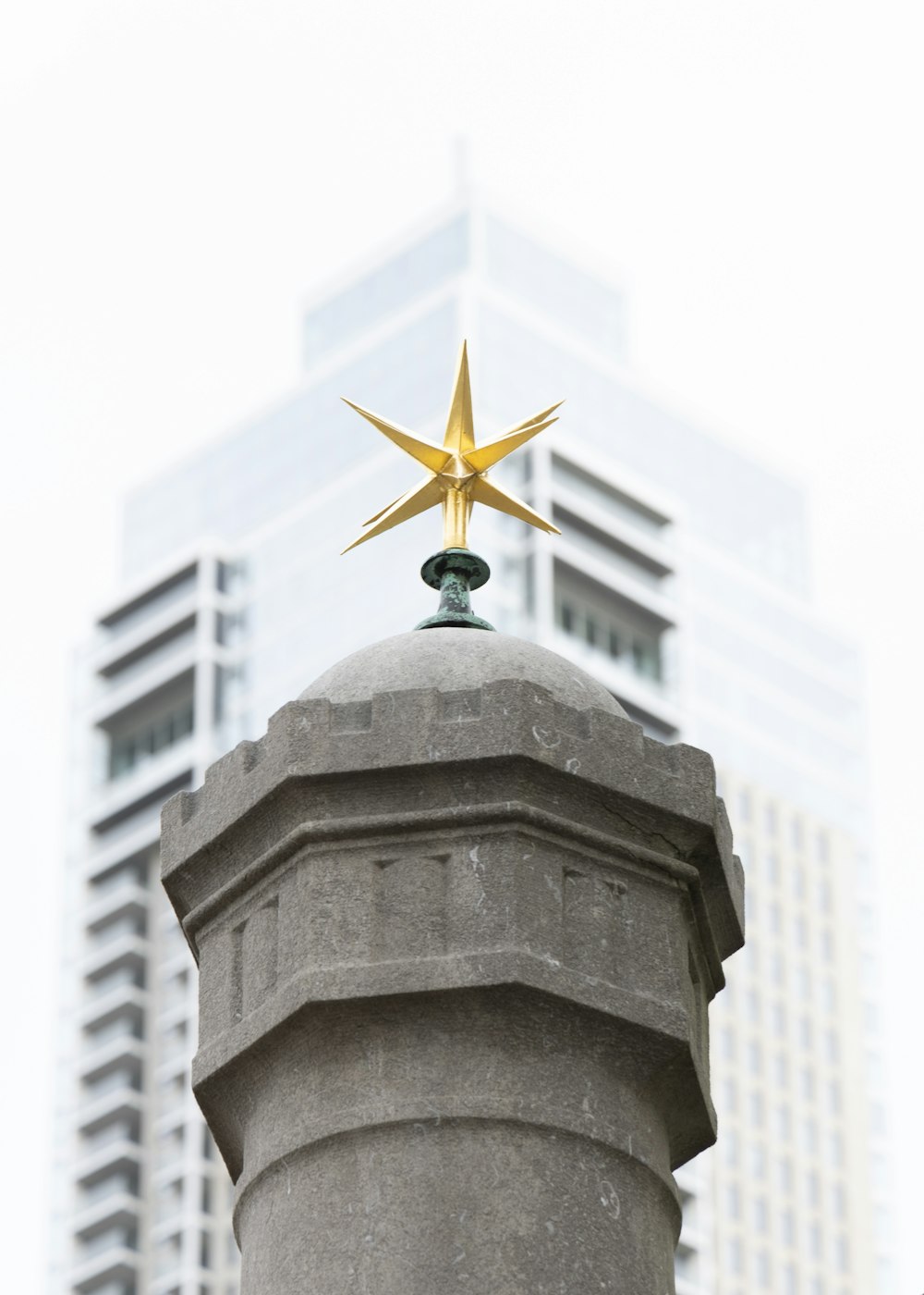 a star on top of a building in a city