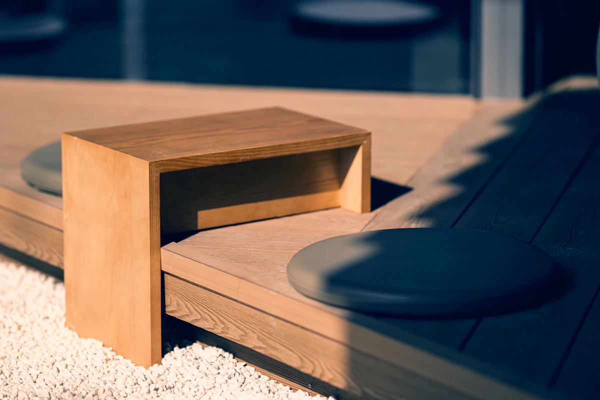 a wooden bench sitting on top of a white rug