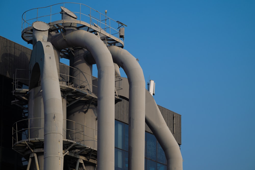 a tall building with a lot of pipes on top of it