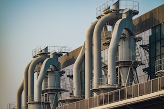 a row of pipes on a building with a sky background