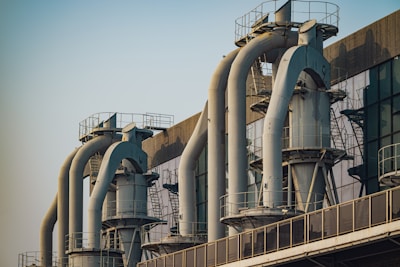 a row of pipes on a building with a sky background