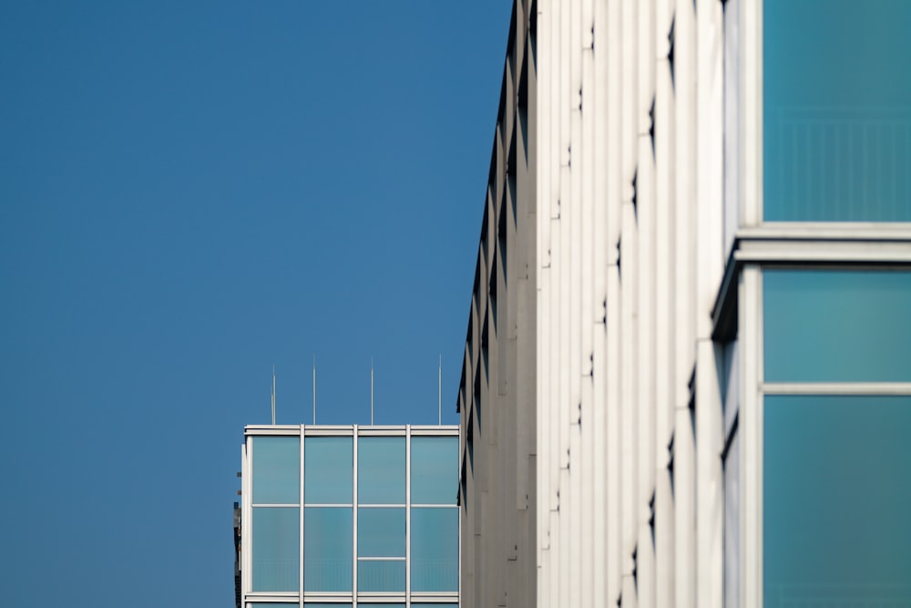 a tall white building next to a tall white building