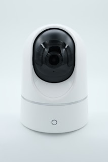 a white camera on a white surface