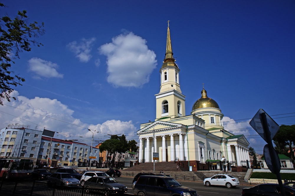 a church with a steeple and a golden dome