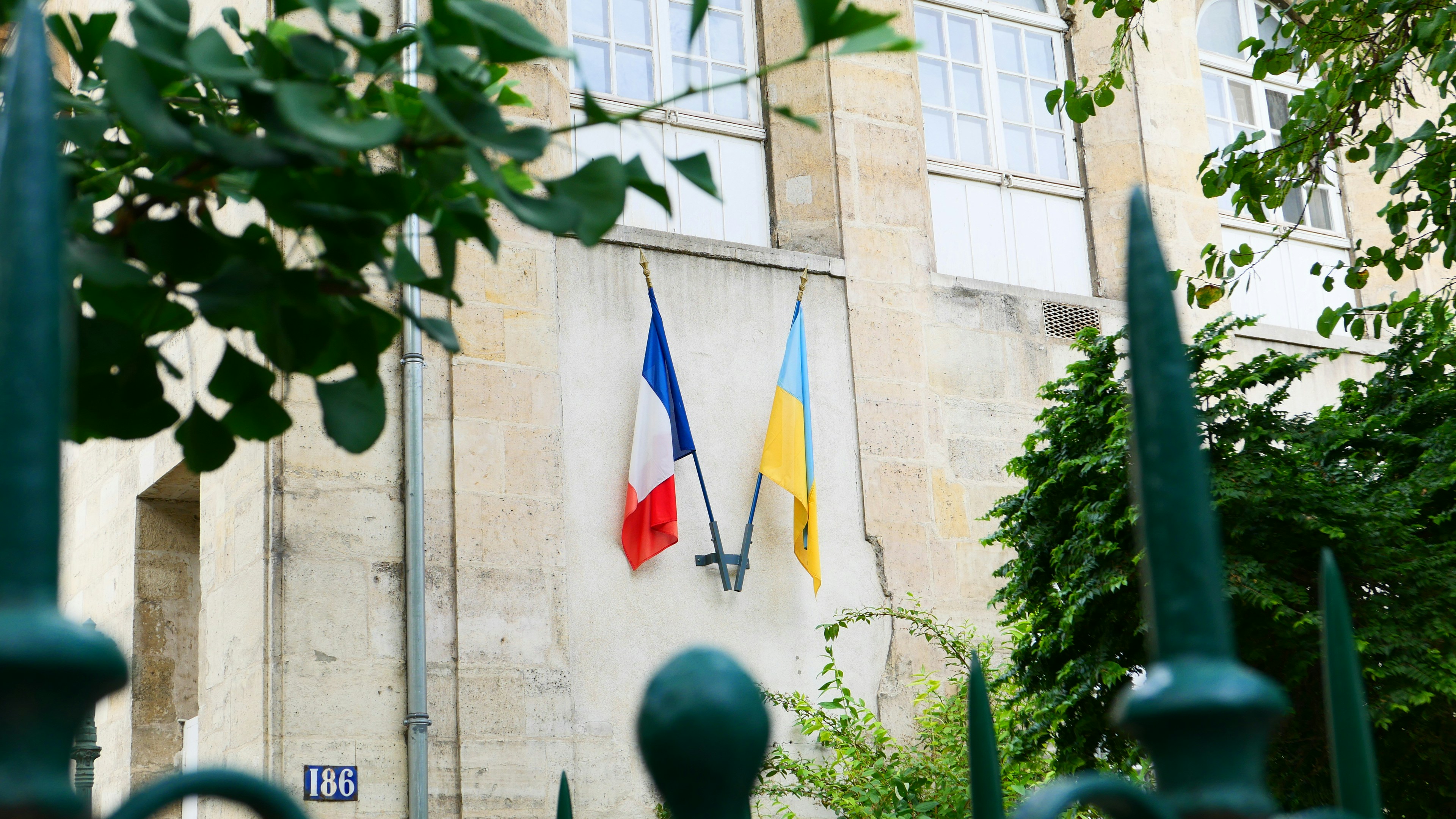 A building with three flags on the side of it