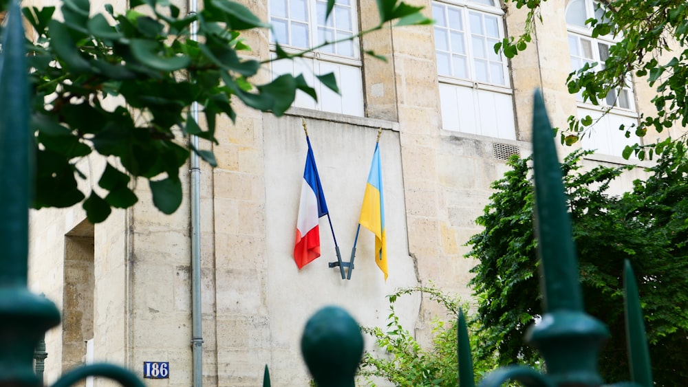 a building with three flags on the side of it