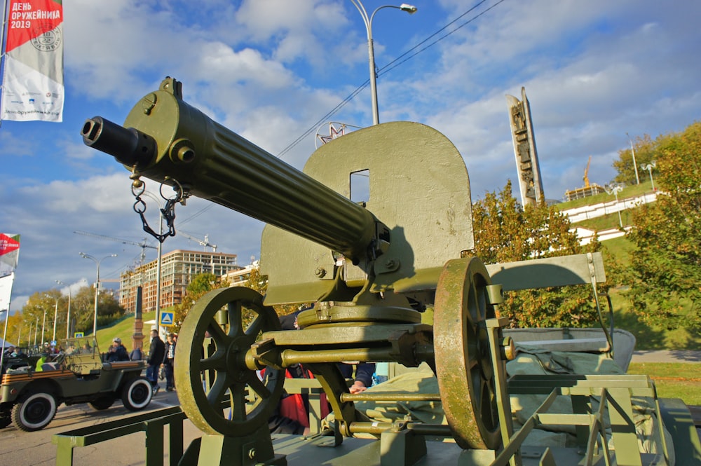 a large metal cannon sitting on top of a wooden stand