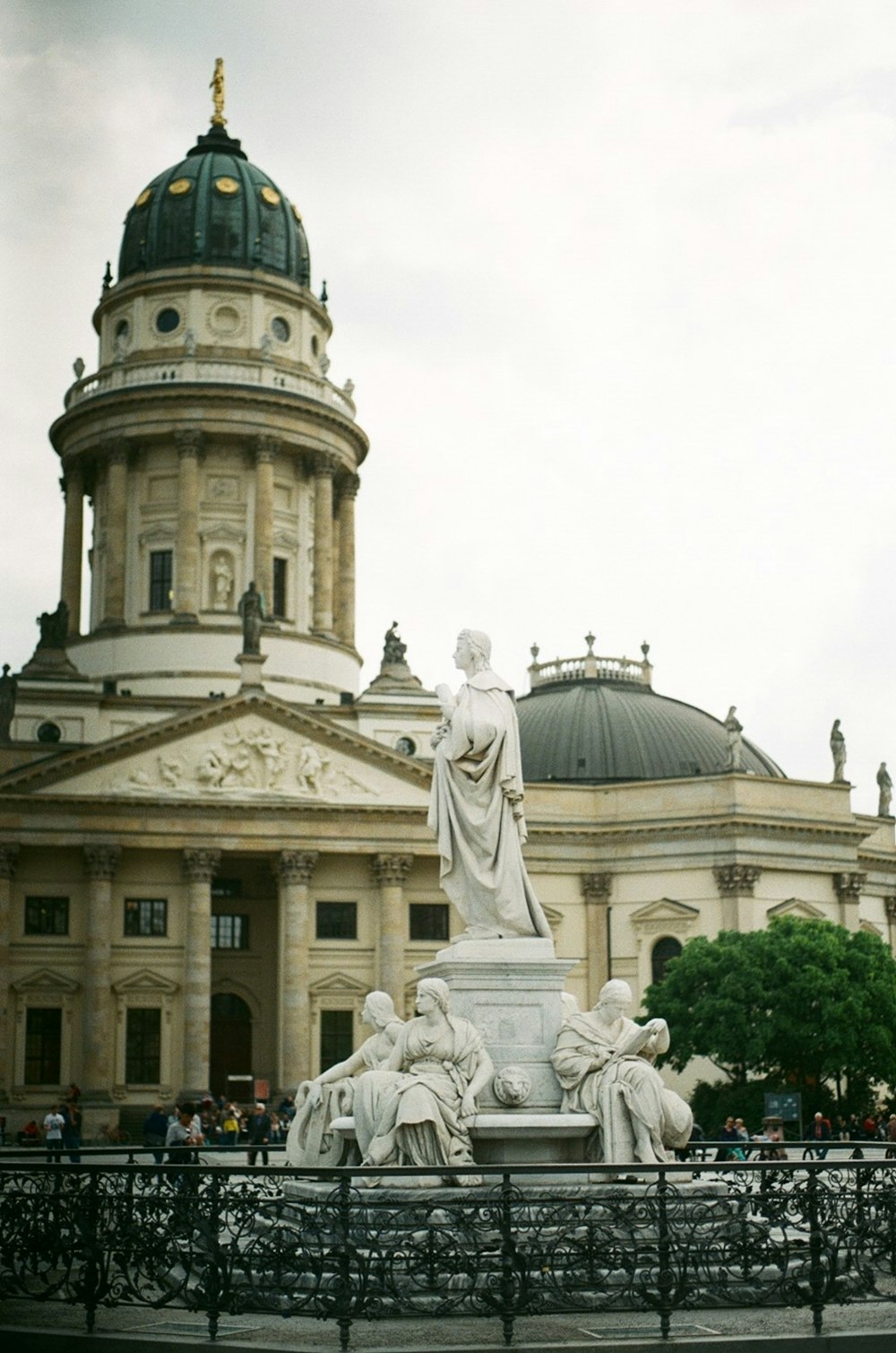 a large building with a statue in front of it