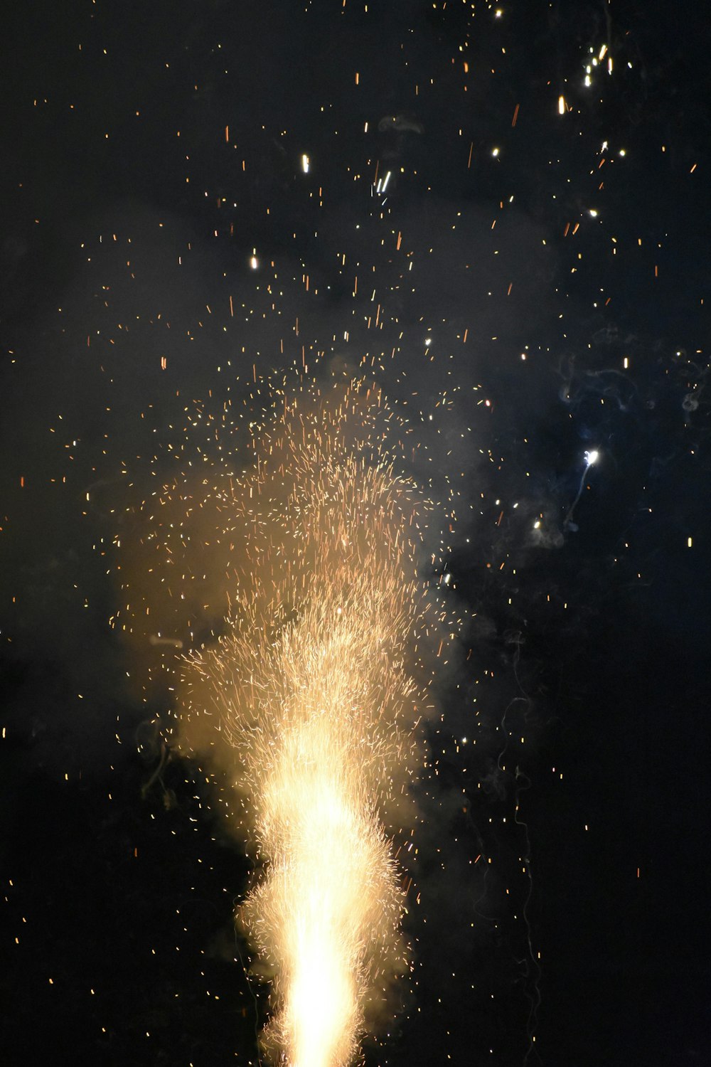 a firework is lit up in the night sky
