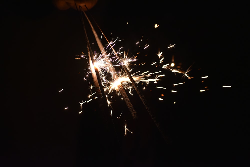 a person holding a sparkler in the dark