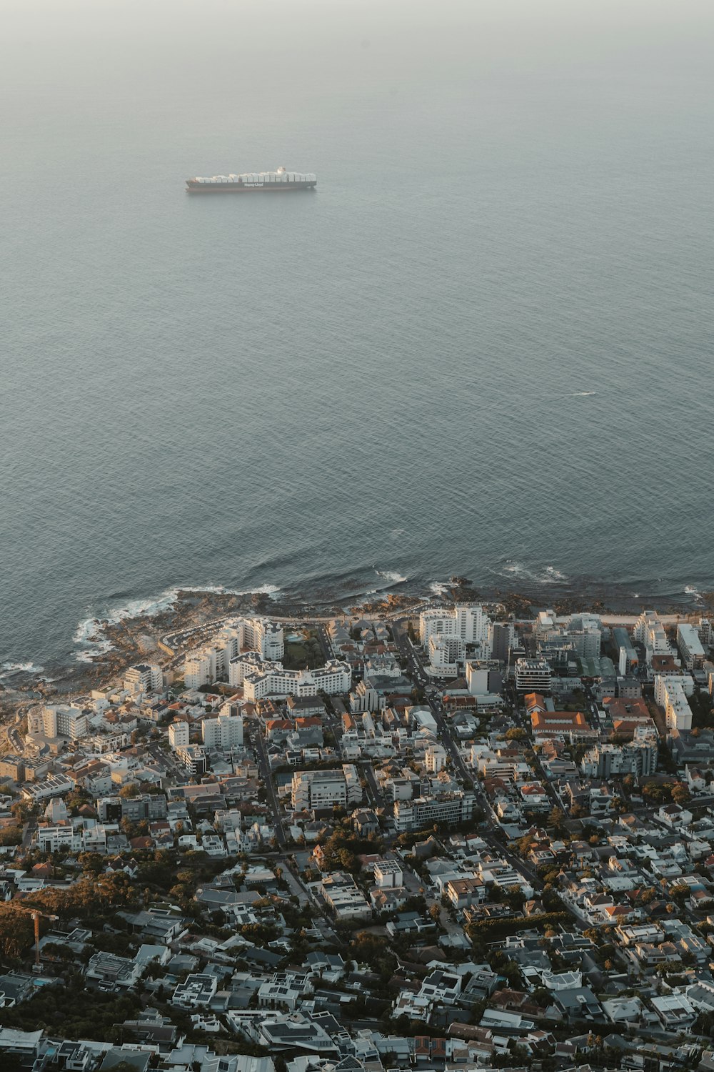 an aerial view of a city by the ocean