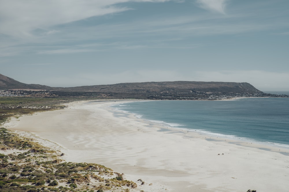 a view of a beach with a mountain in the background