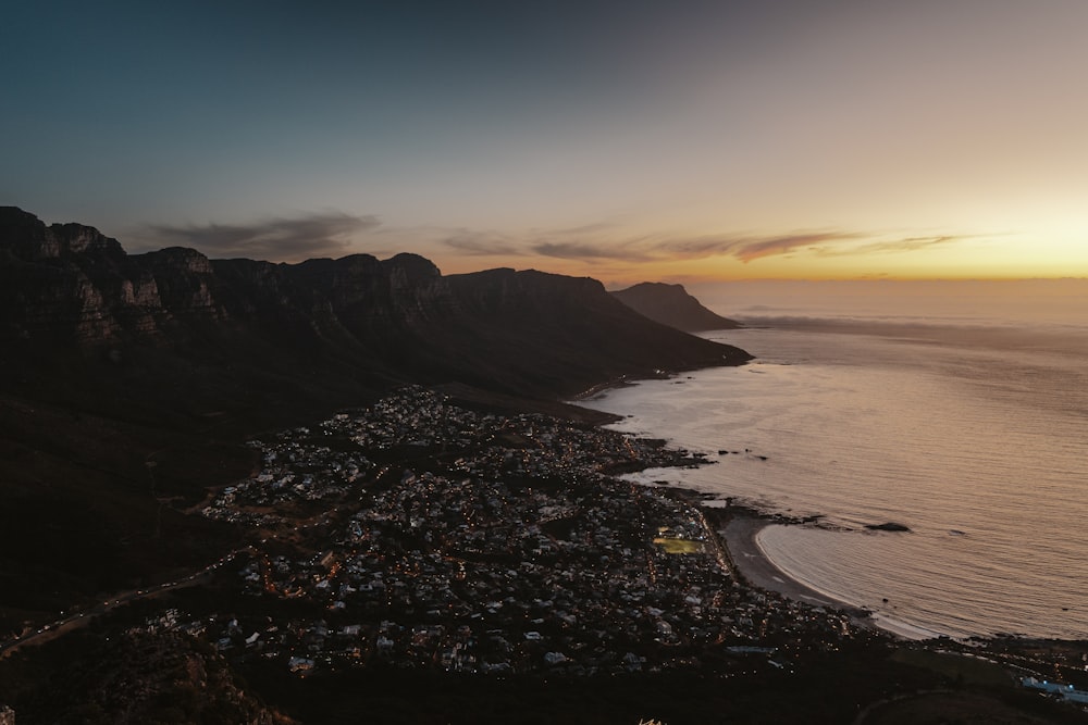 an aerial view of a city next to a body of water