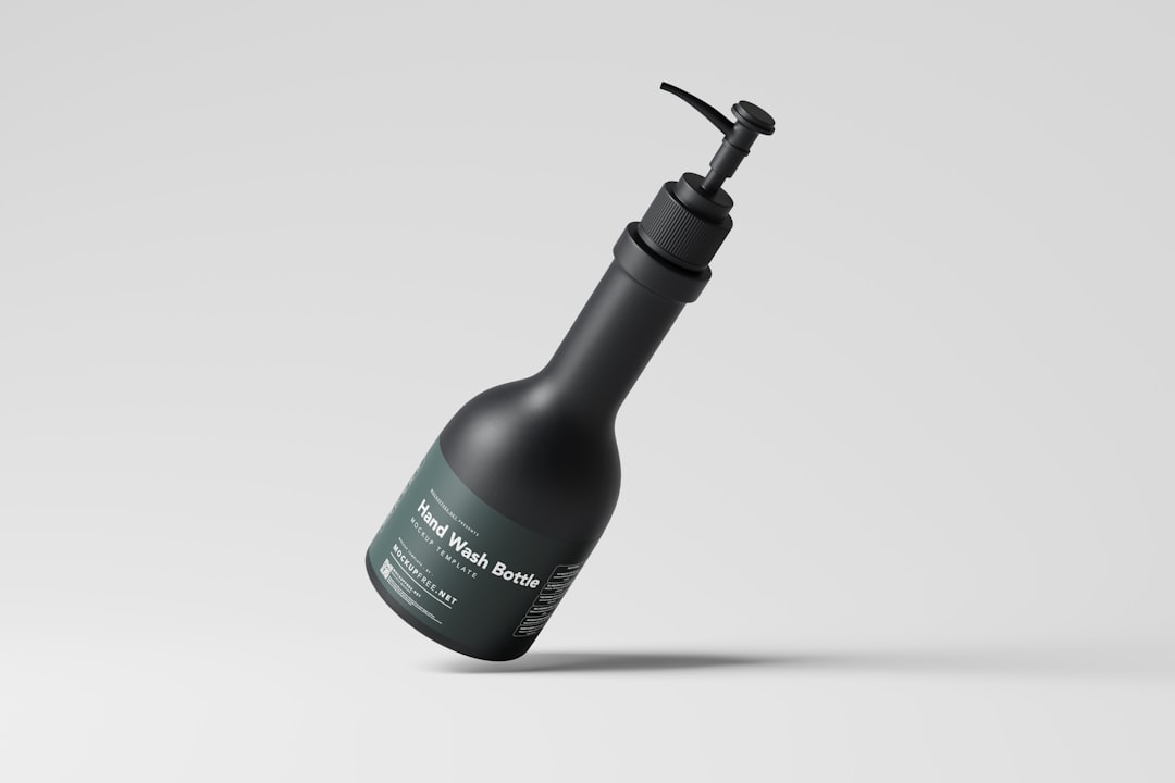 a bottle with a black cap and a black handle, Hand Wash Pump Bottle Mockup Sleek and Modern Hand Wash Bottle Mockups: Present Your Product with Sophistication Download this mockup set for free from Mockup Free : https://mockupfree.net