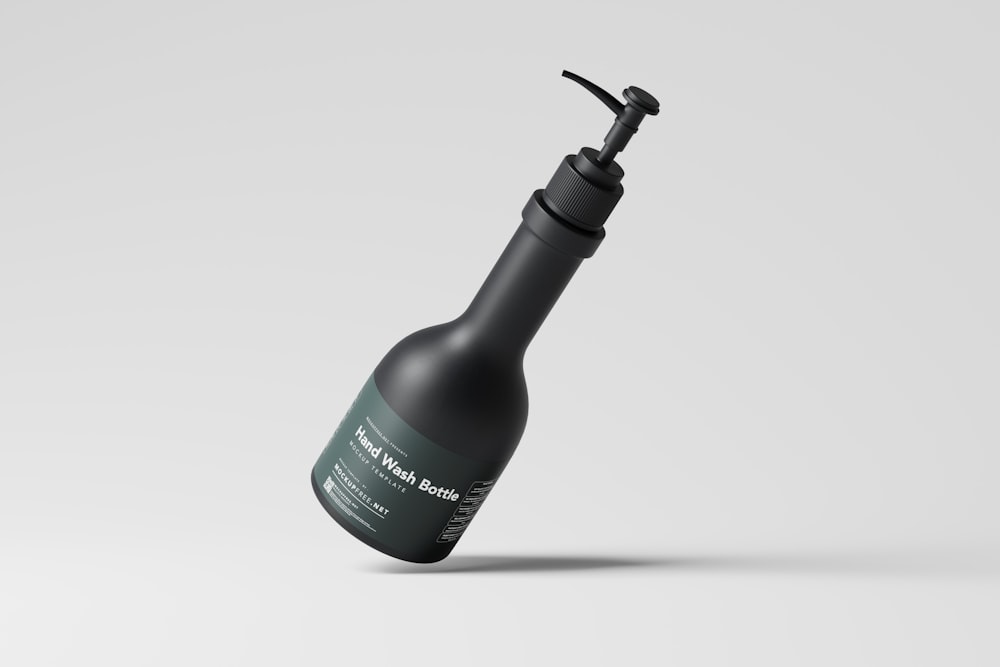 a bottle with a black cap and a black handle