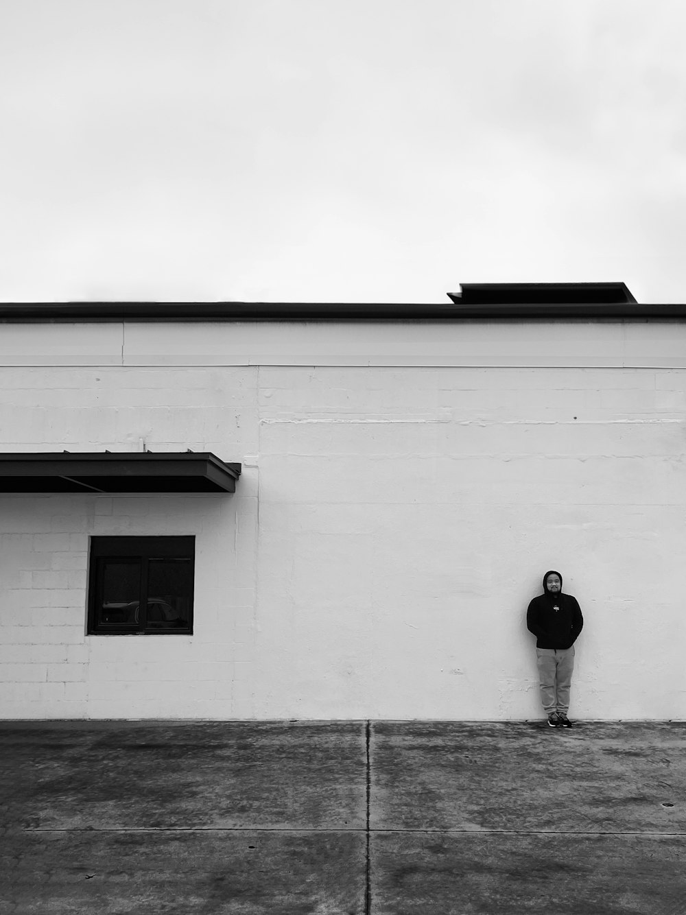 a man standing in front of a white building