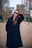 a woman in a black coat and sunglasses