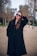 a woman in a black coat and sunglasses