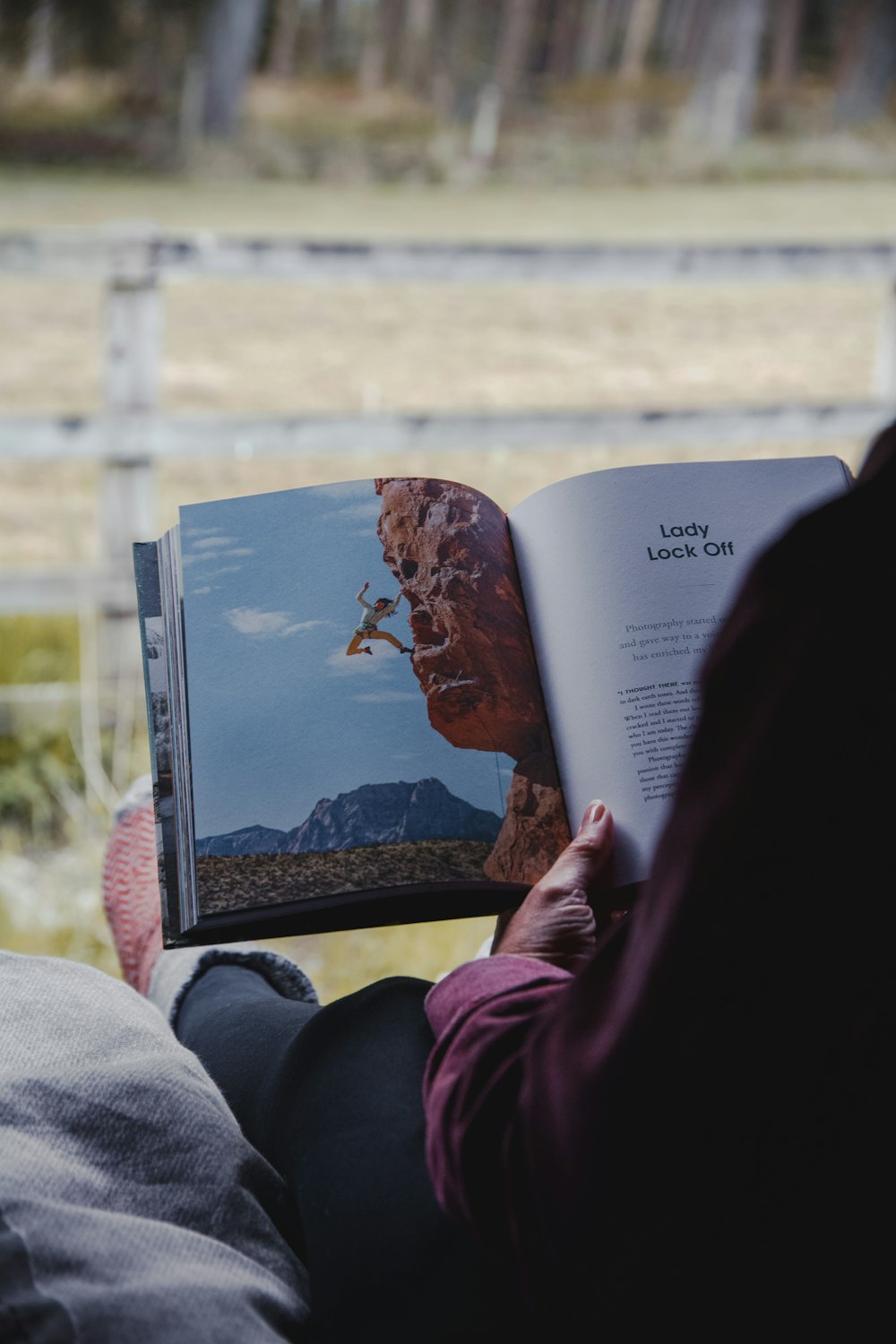 a person sitting in a chair reading a book