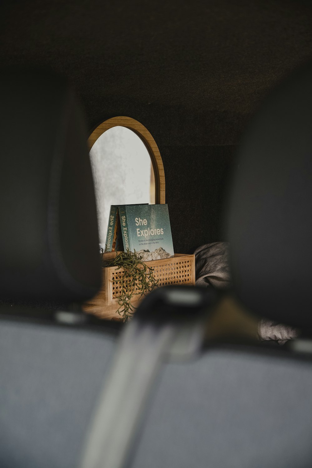 a mirror sitting on top of a wooden shelf