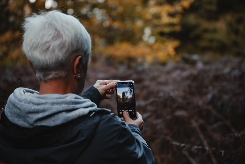 a person taking a picture with a cell phone