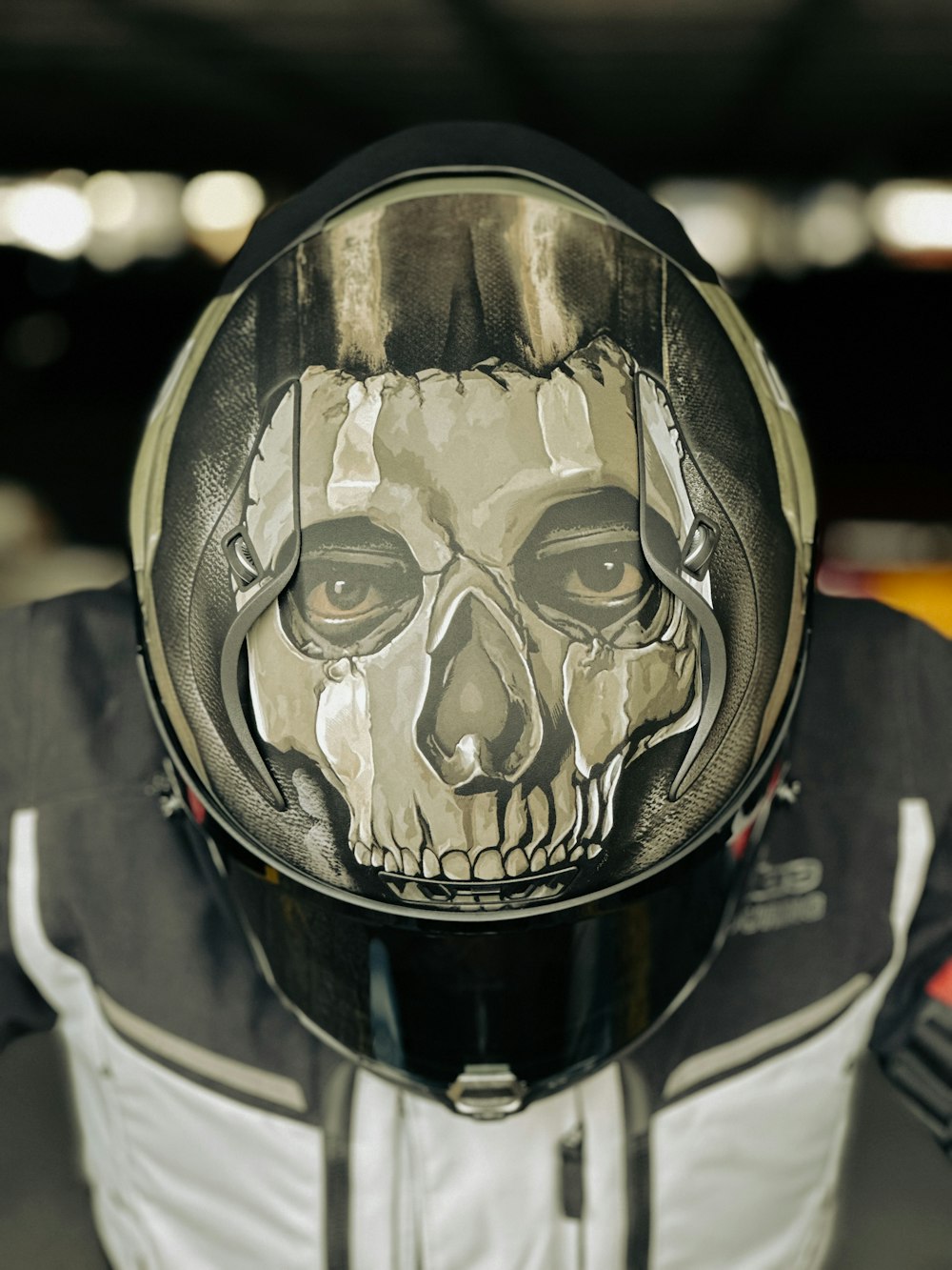 a person wearing a motorcycle helmet with a skull painted on it