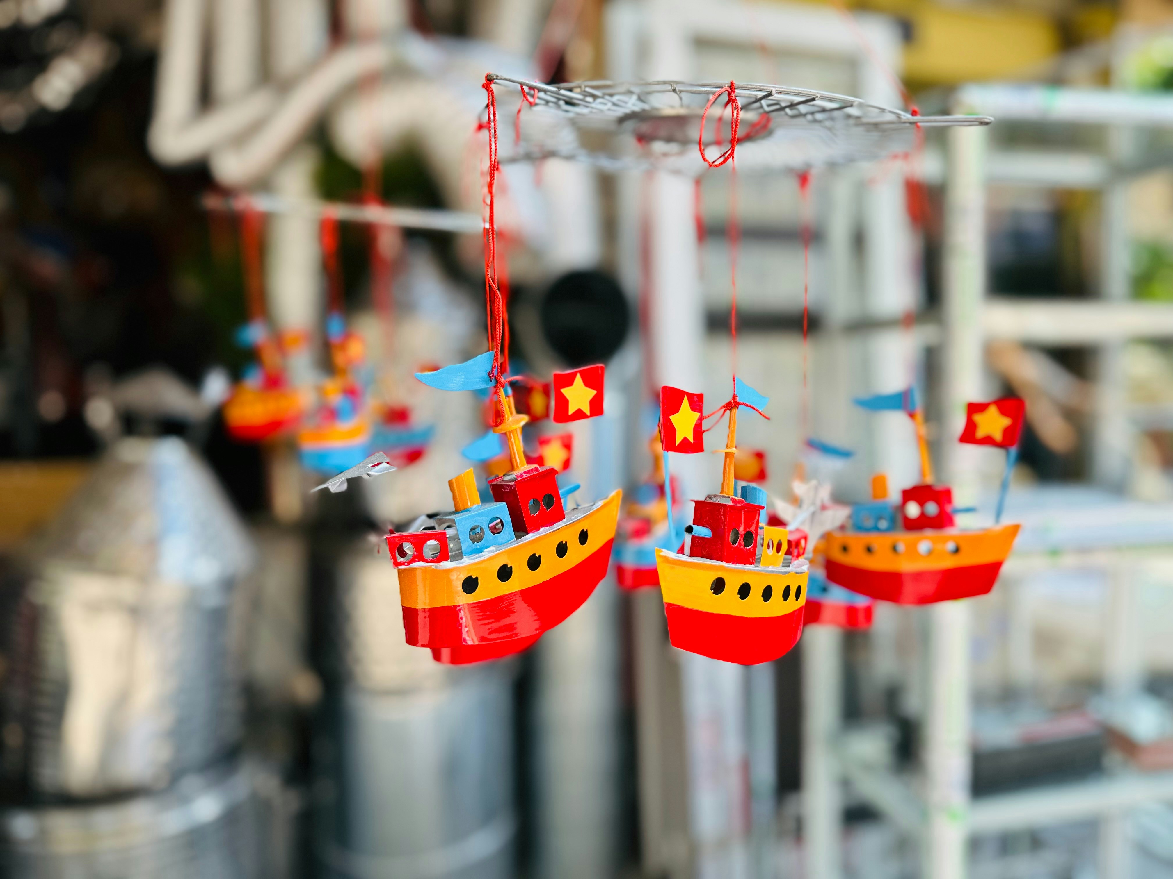 a wind chime with a red and yellow boat on it