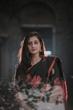 a woman in a black and red sari