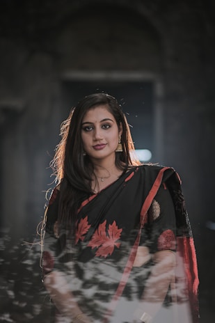 a woman in a black and red sari
