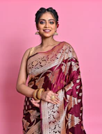 a woman wearing a maroon and gold sari