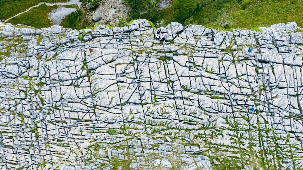 an aerial view of a rock wall with grass growing on it