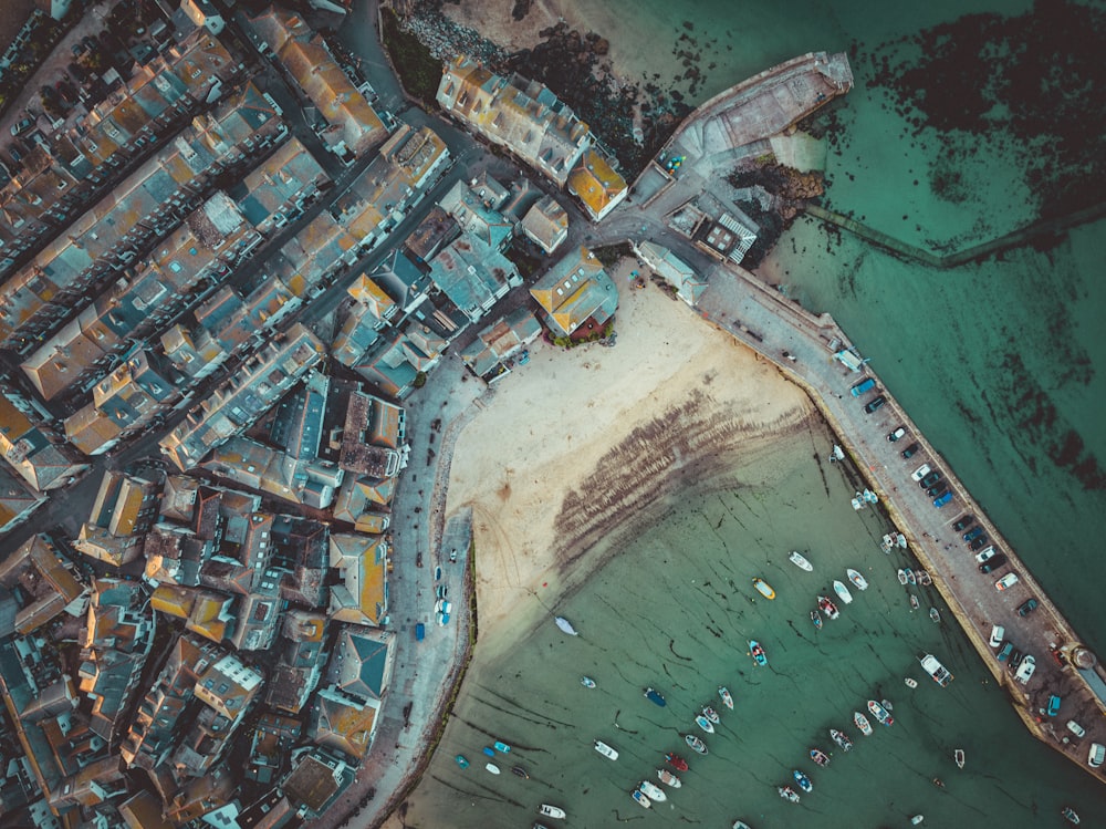 a bird's eye view of a city next to a body of water