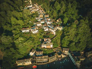 an aerial view of a village surrounded by trees