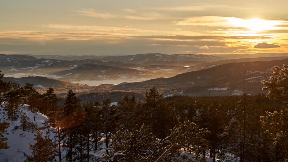 the sun is setting over a mountain range