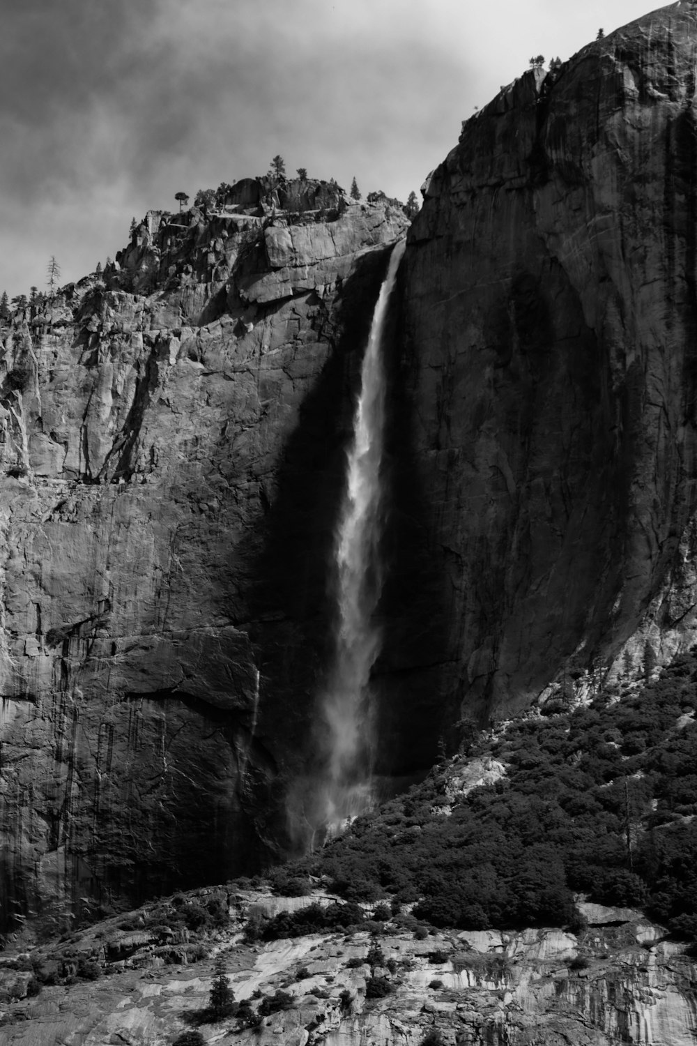 a black and white photo of a waterfall