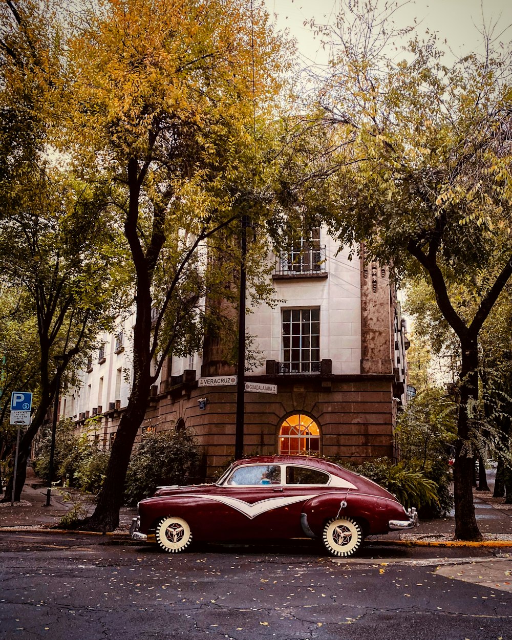 a car parked on the side of the road in front of a building