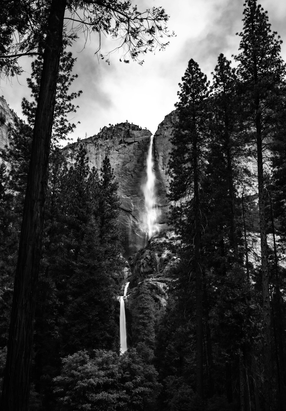 a black and white photo of a waterfall