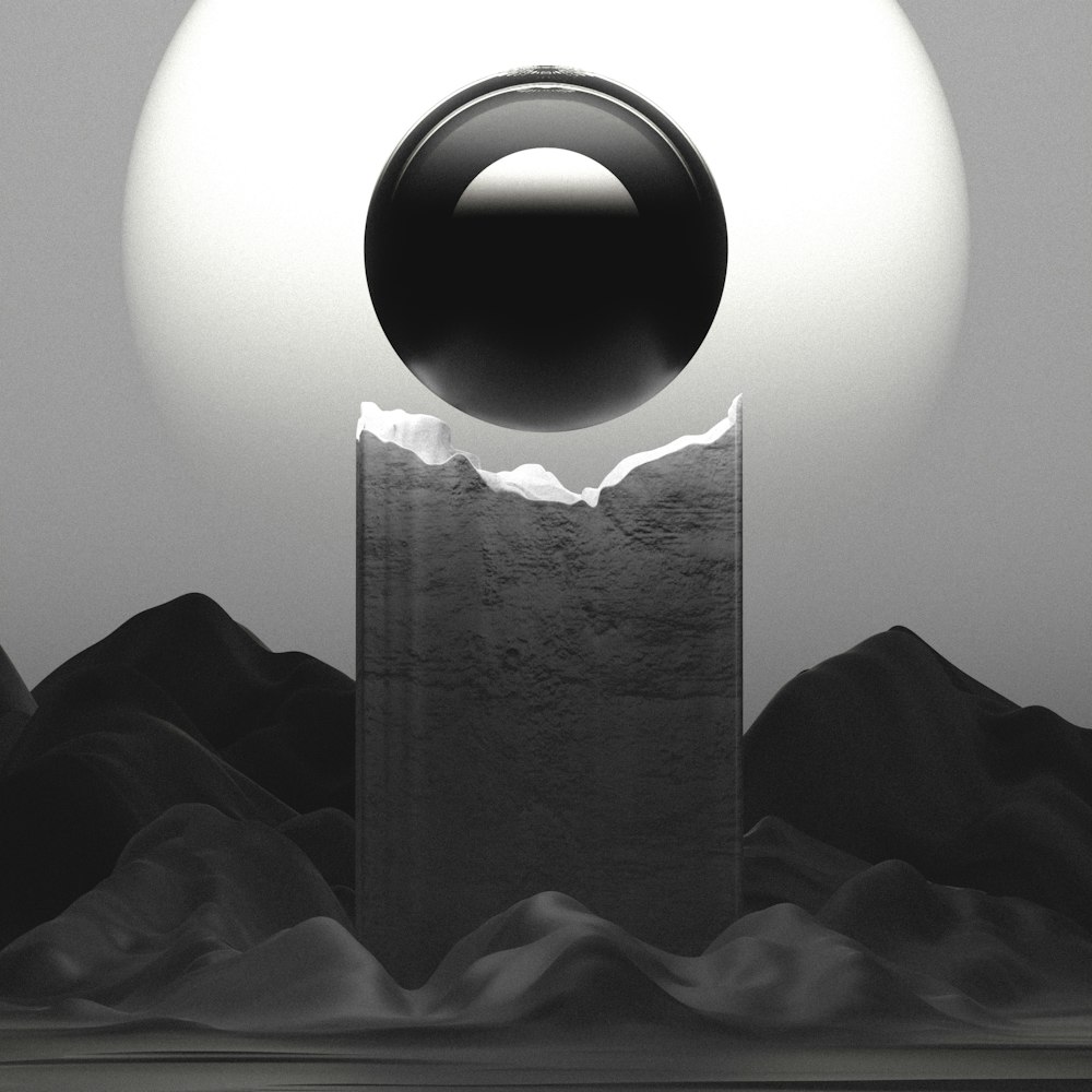 a black and white photo of a ball on a pedestal