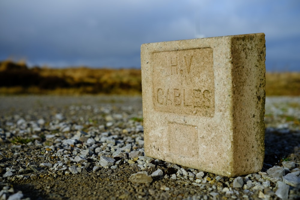 a cement block sitting on top of a gravel field